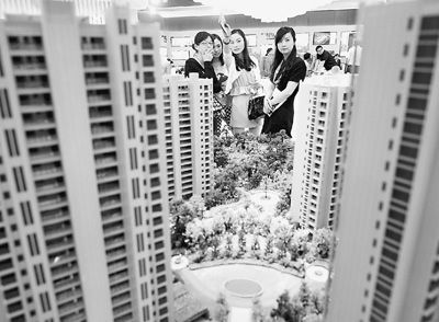 圖為近日，浙江杭州一家房產(chǎn)公司的兩位銷售人員一起向購房者介紹樓盤。新華社記者 王定昶攝