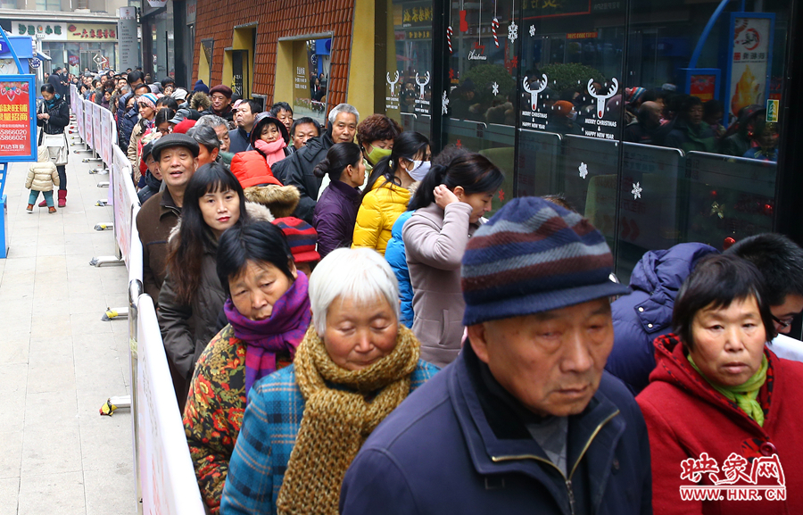 領(lǐng)粥的市民排起了長隊，足有上千人。