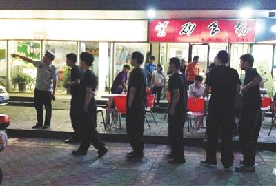 6月13日晚10點，朝陽區(qū)國美第一城附近，一名城管隊員帶領(lǐng)一隊協(xié)管例行巡查街邊大排檔。新京報記者 尹亞飛 攝
