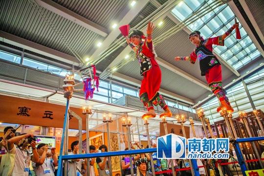 2號(hào)展館，苗族姑娘表演踩燈泡絕技《電光玫瑰》，赤腳踩上40瓦的燈泡并做出高難度動(dòng)作。 南都記者 霍健斌 攝