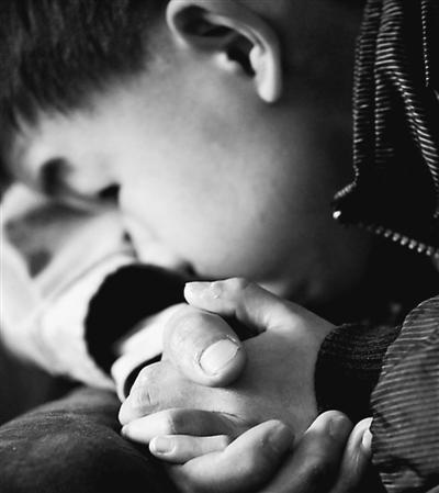 10歲小兒子緊緊握著哥哥的手。資料圖片