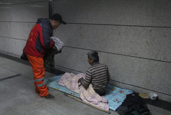 在鄭州一處地下通道，孫德坤挑了幾件衣服送給了流浪者
