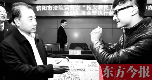 張立勇將依法執(zhí)行回來的農(nóng)民工工資發(fā)放給案件當事人游昌華，游昌華施以中國傳統(tǒng)作揖禮答謝