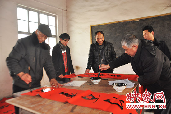 鞏義市魯莊鎮(zhèn)農(nóng)民書法愛好者正在寫春聯(lián)。