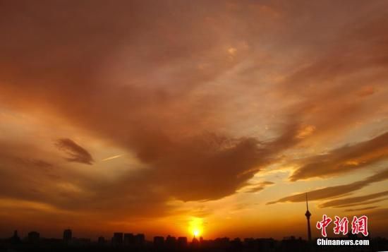 12月8日下午，強烈的西北風(fēng)光臨北京，吹散了籠罩全城上空的霧霾，冬日罕見的艷麗晚霞映紅了半邊天。
