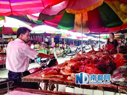  昨日，玉林垌口市場，一位市民在購買狗肉。