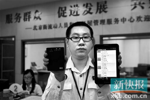 　越秀區(qū)北京街出租屋外來暫住人員管理服務(wù)中心的工作人員展示到出租屋登記來穗人員信息的儀器。