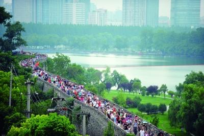 　　昨天,數(shù)萬(wàn)南京市民參加“環(huán)城七十里”徒步走,圖為解放門城墻上密集的人群。 本版攝影 實(shí)習(xí)生 王甜